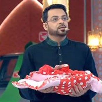 Aamir Liaquat with a baby in arms Aamir Liaquat with a baby in arms